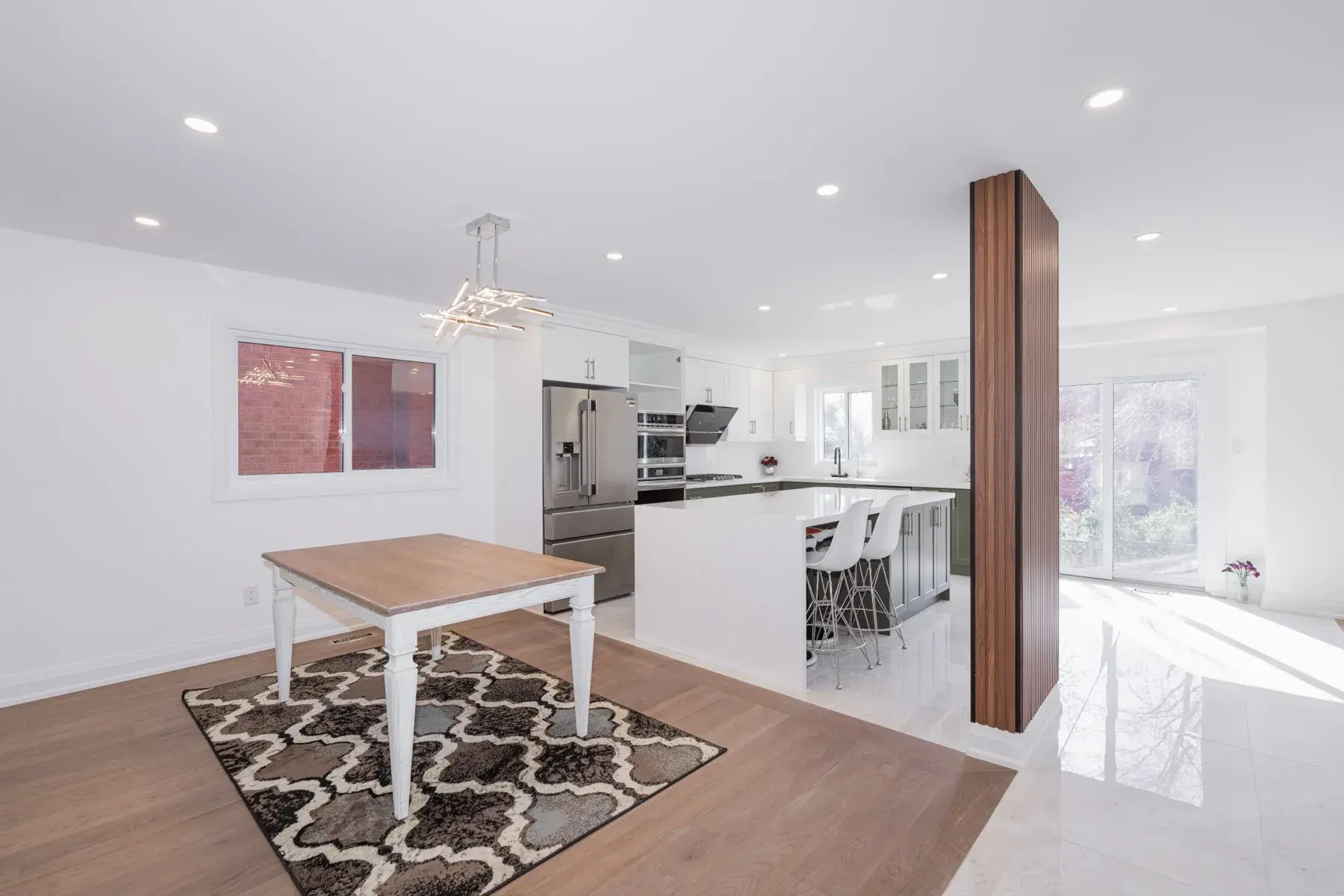 A finished whole-home renovation: open kitchen and dining with a timber-clad column (photograph supplied by the client)