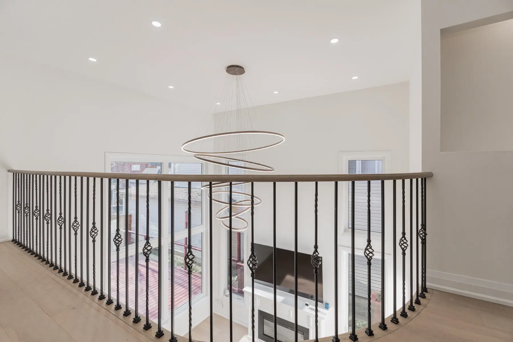 A finished addition: an open landing, iron balusters and a ring pendant (photograph supplied by the client)