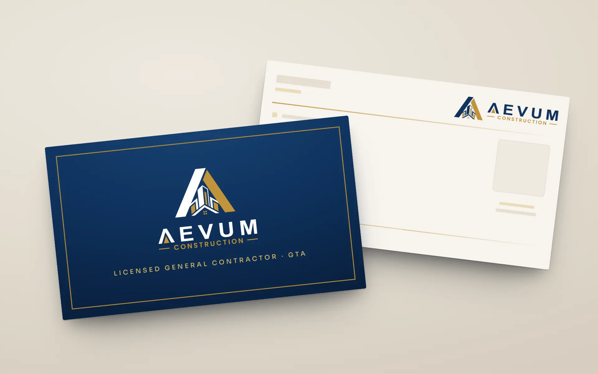 The AEVUM business card, front and back, on a pale stone ground: the navy front carries the white-and-gold mark inside a fine gold frame