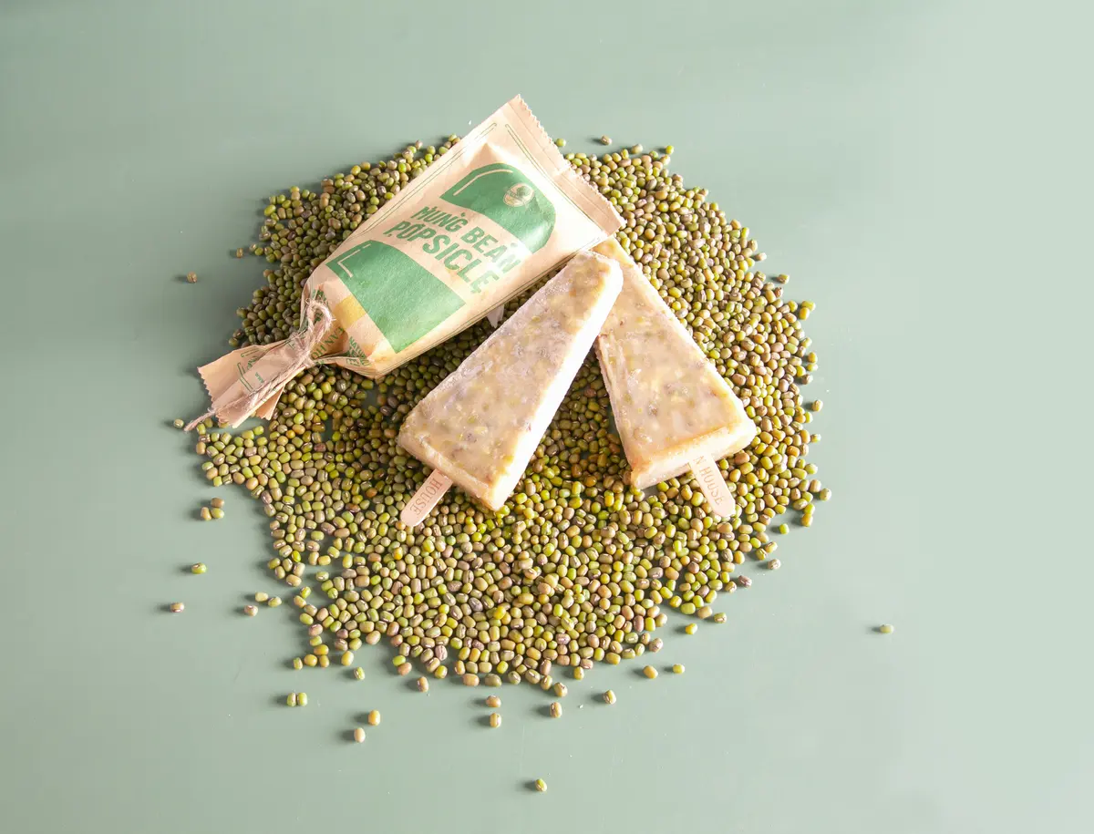 Mung bean popsicles and wrapper on a heap of mung beans (photograph supplied by the client)
