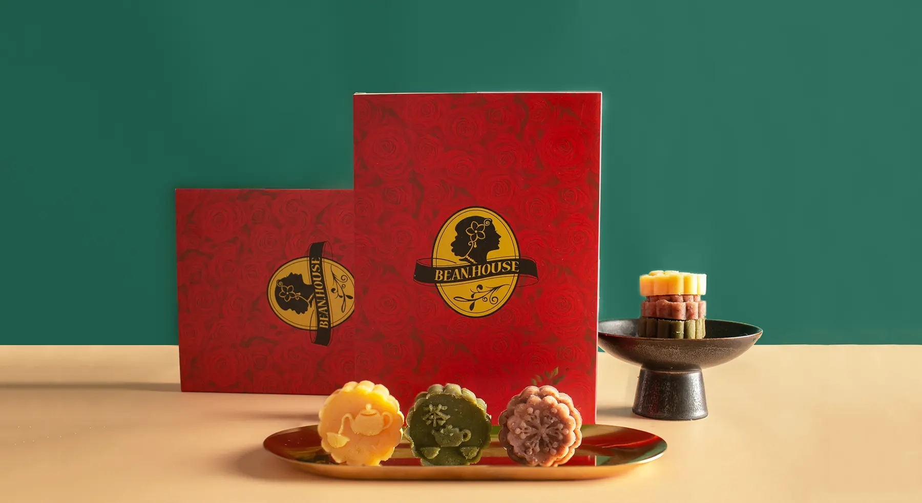 Two red gift boxes with the gold seal and three bean cakes (photograph supplied by the client)