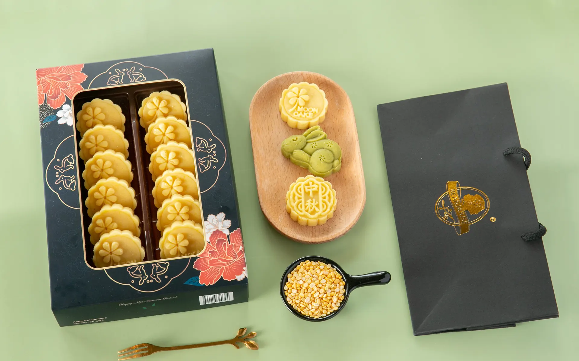 A Bean House Mid-Autumn box, a tray of bean cakes and a carrier with the gold seal on green (photograph supplied by the client)