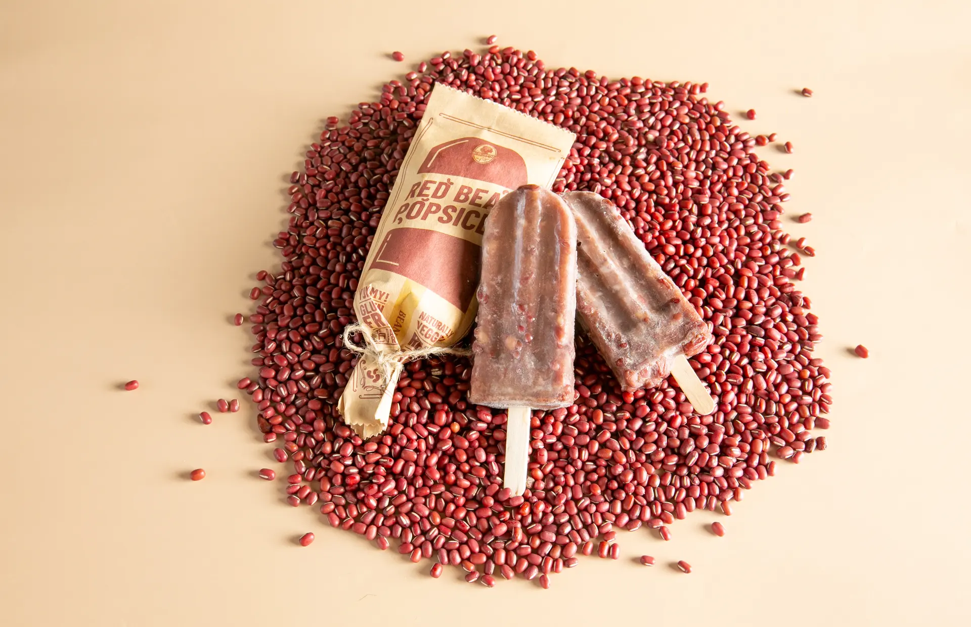 Red bean popsicles on a heap of adzuki beans (photograph supplied by the client)