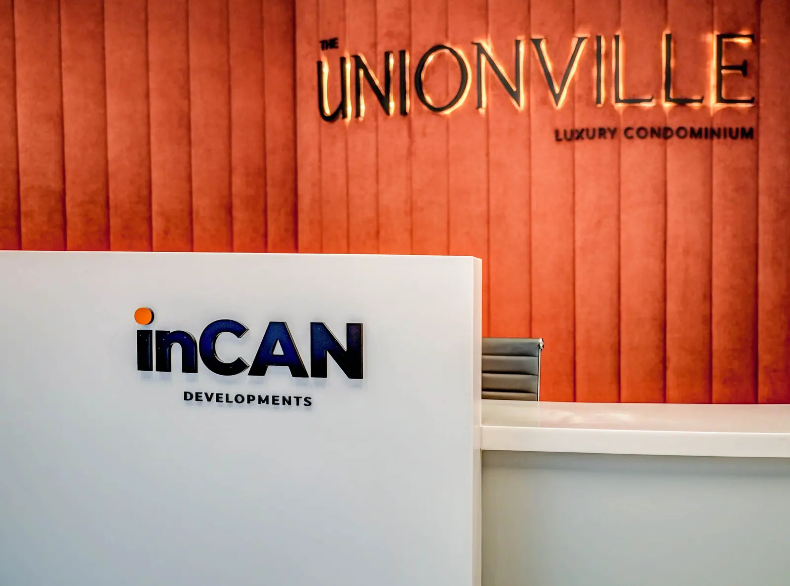 Presentation centre: the inCAN desk in front of The Unionville wordmark on a rust velvet wall