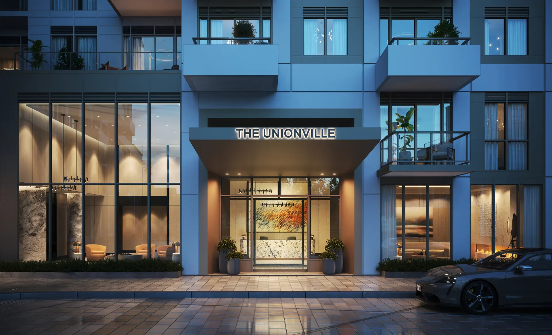 Entrance rendering at night: The Unionville sign above the glass lobby