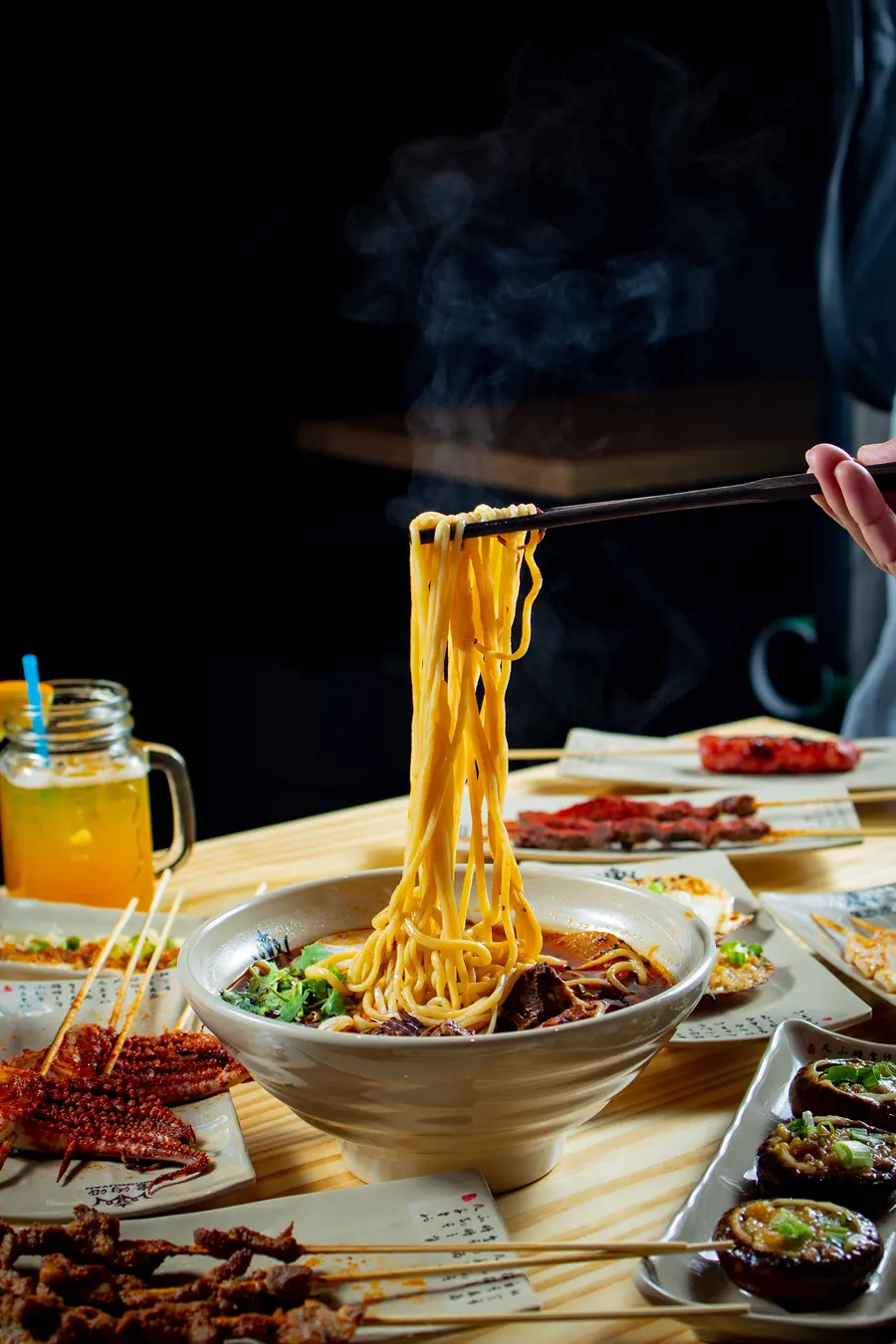 Steam rising from a freshly lifted tangle of noodles