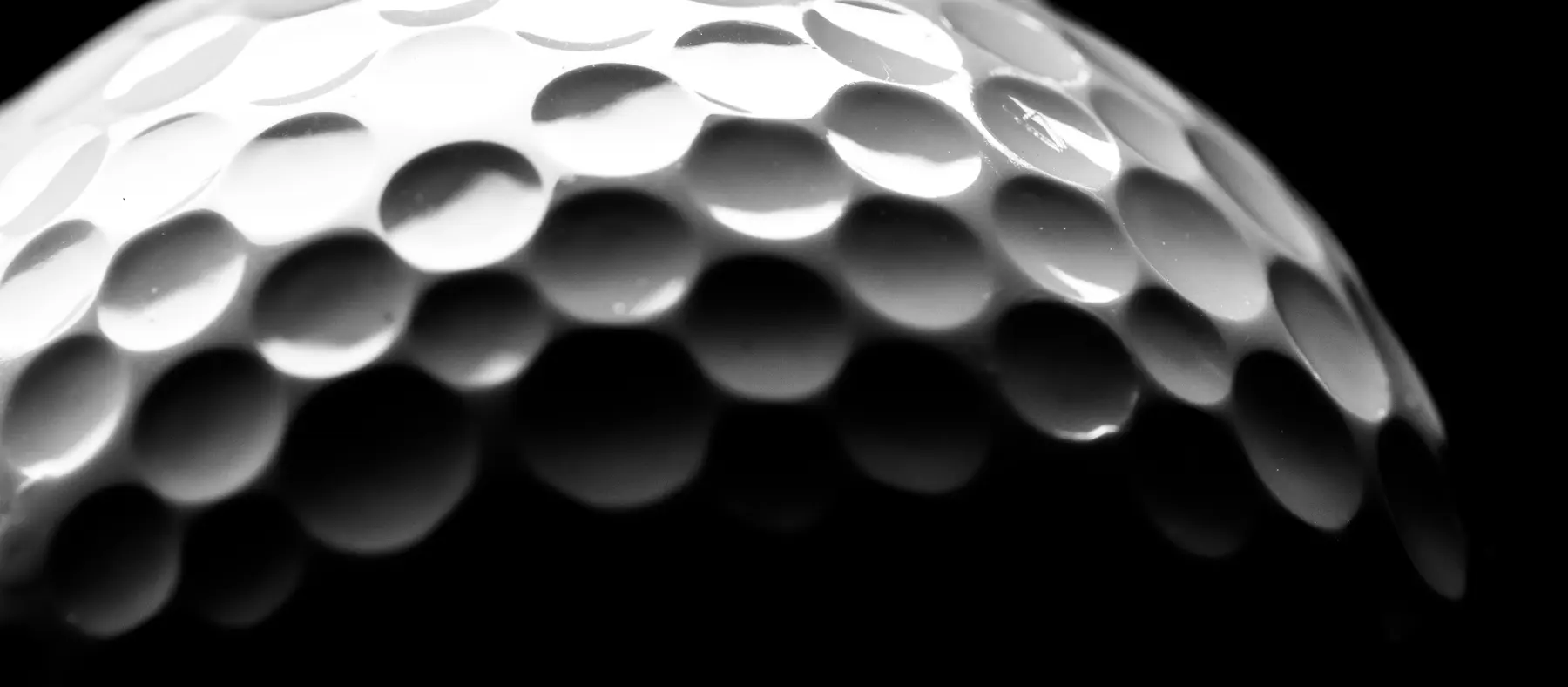 Close on the dimples of a golf ball