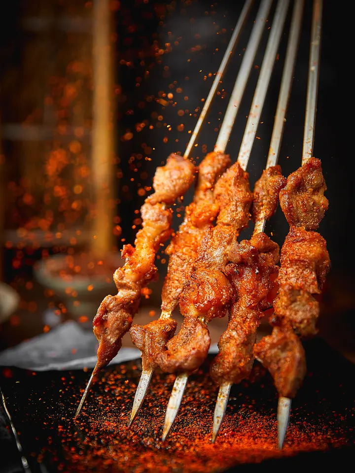Poster: “烧烤记忆” (BBQ memories) set vertically beside skewers in a shower of sparks