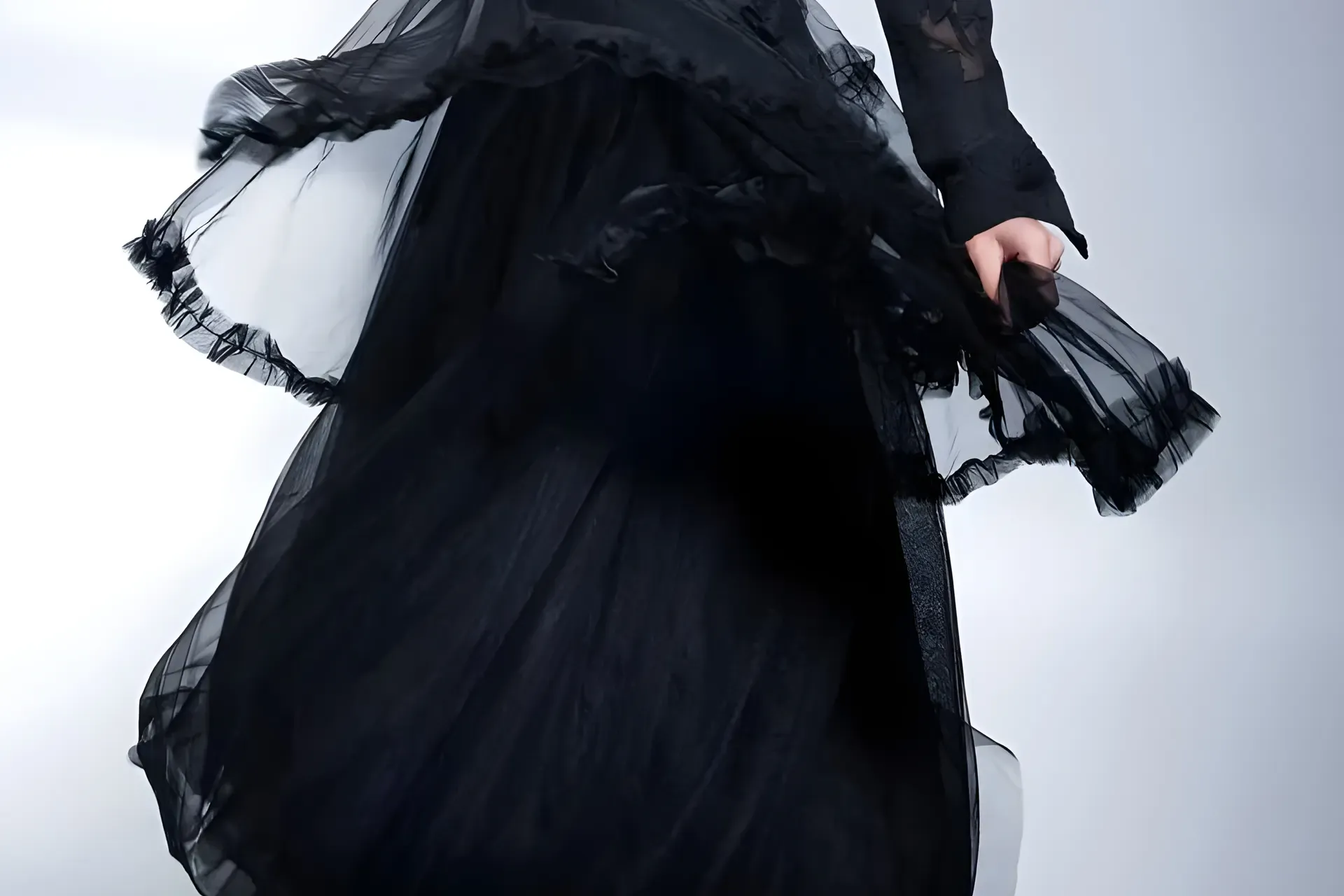 A black tulle skirt lifting on the turn (cropped from the 2023 competition shoot; no face in frame)