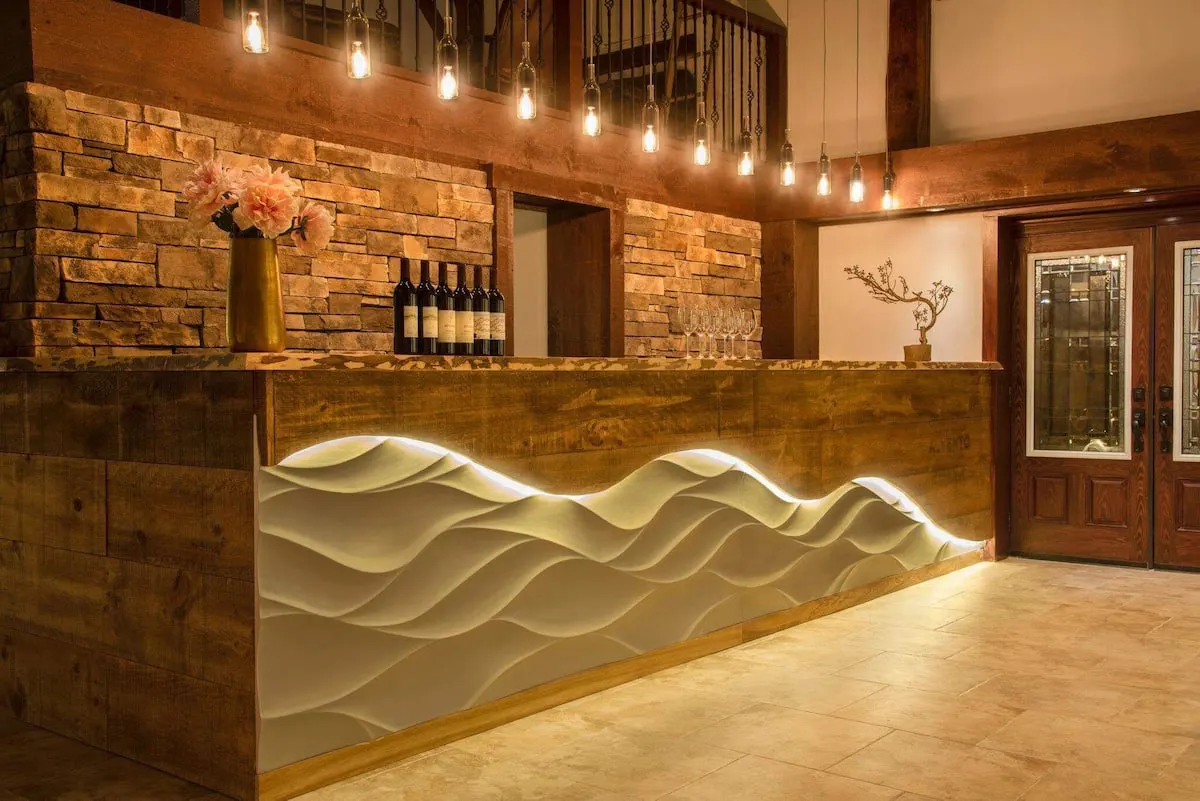 Alvento’s tasting room: a white, wave-shaped bar against timber walls